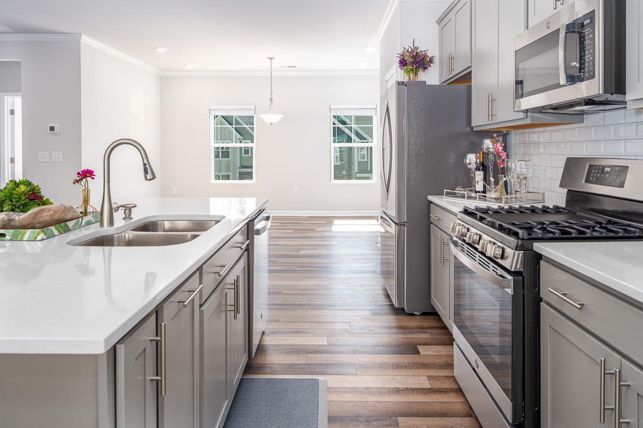 1434 Rosepine Drive Cary, NC 27519 - Photo 8 of 32 a kitchen with stainless steel appliances granite countertop a sink stove and cabinets