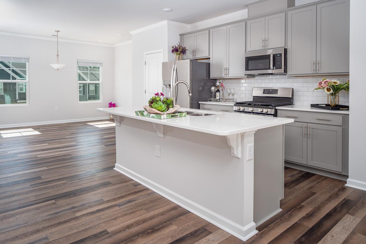 1434 Rosepine Drive Cary, NC 27519 - Photo 9 of 32 a kitchen with stainless steel appliances granite countertop a sink a stove and cabinets