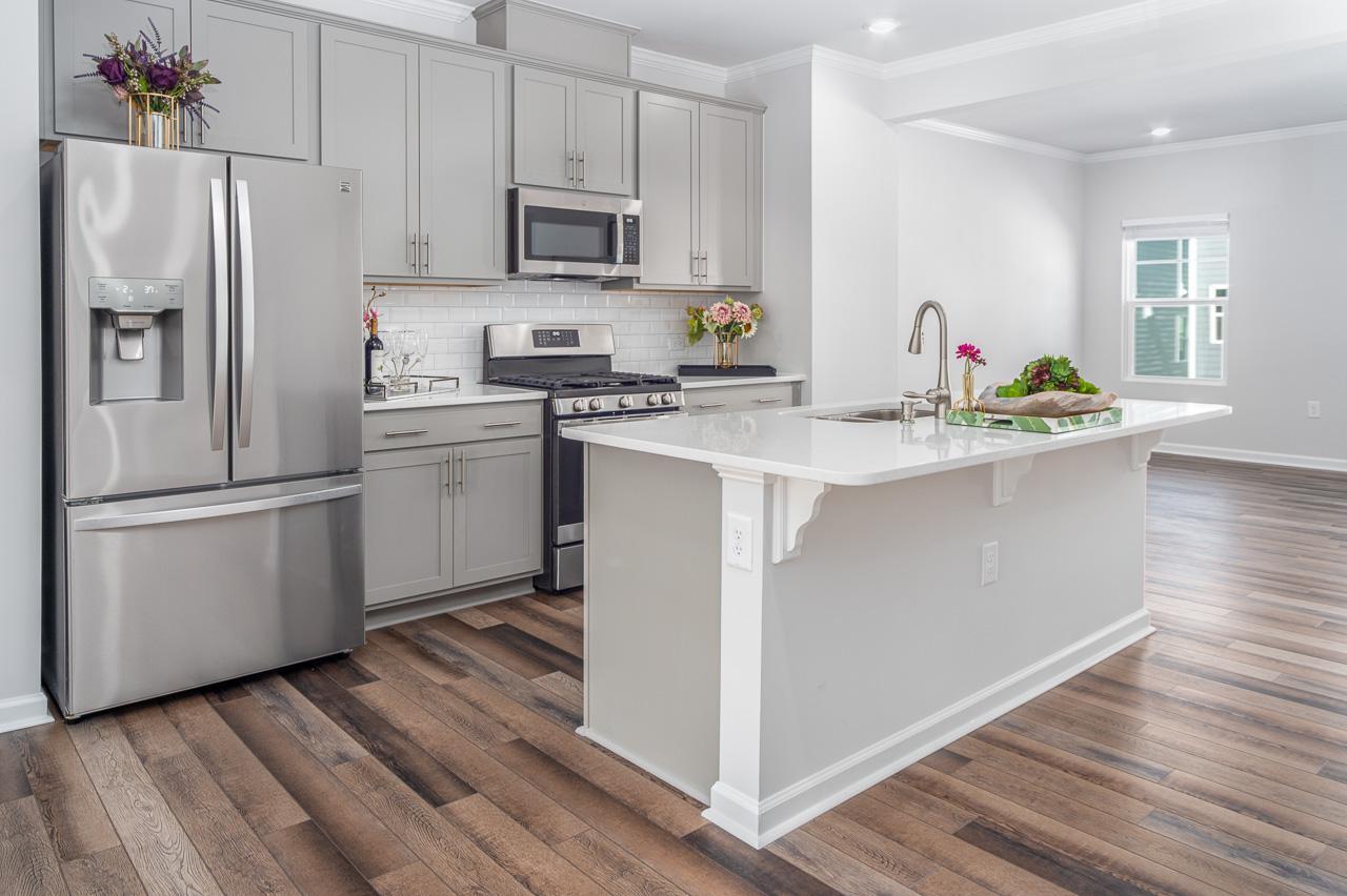1434 Rosepine Drive Cary, NC 27519 - Photo 10 of 32 a kitchen with stainless steel appliances a refrigerator sink and microwave