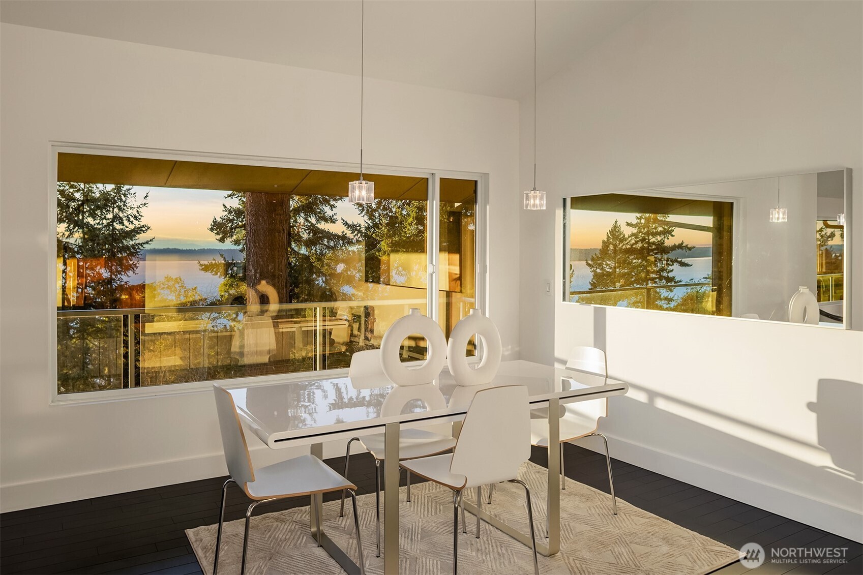 15733 25th Avenue Southwest Burien, WA 98166 - Photo 16 of 38 a view of a dining room with furniture large windows and wooden floor
