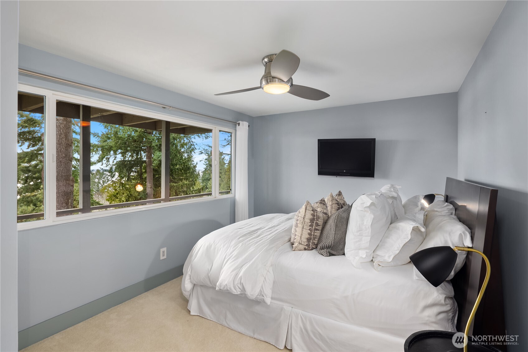 15733 25th Avenue Southwest Burien, WA 98166 - Photo 28 of 38 a bedroom with a bed and a chandelier