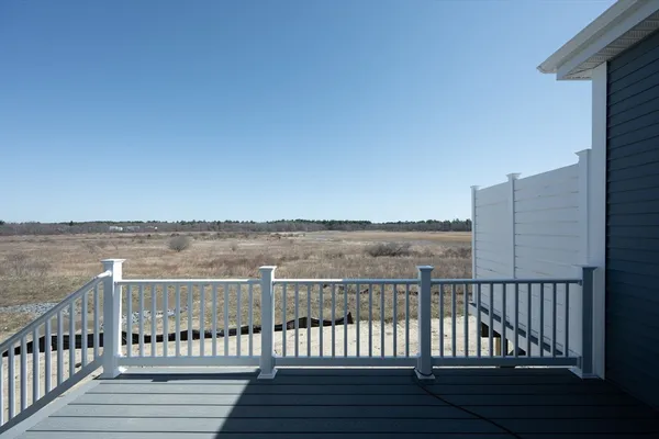 a view of a roof with wooden floor and fence