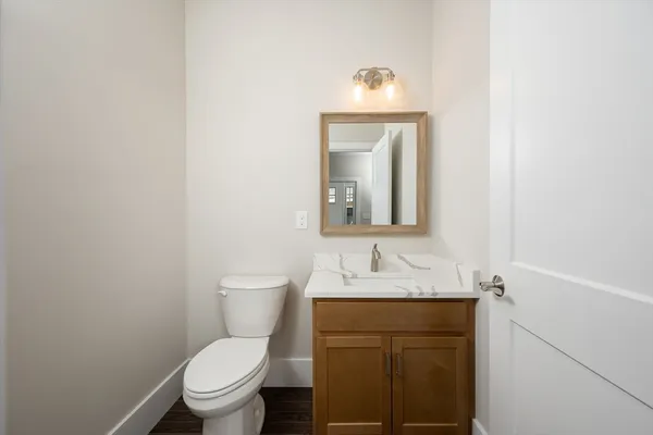a bathroom with a toilet sink and mirror