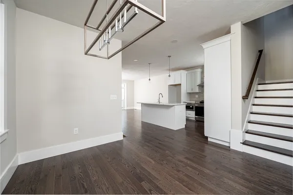 a view of a kitchen with wooden floor and stairs