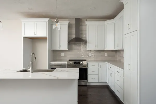 a kitchen with stainless steel appliances white cabinets and a sink