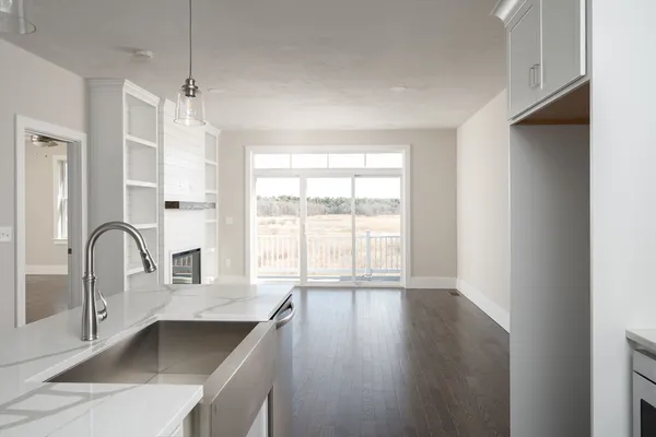 a kitchen with a large window a sink and cabinets