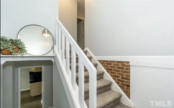 a view of staircase with wooden floor and a potted plant