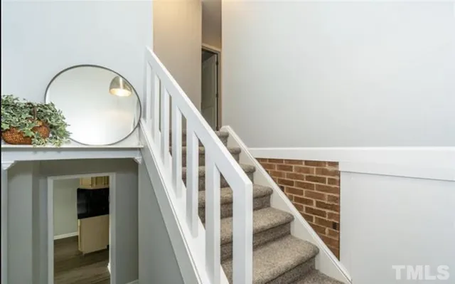 a view of staircase with wooden floor and a potted plant
