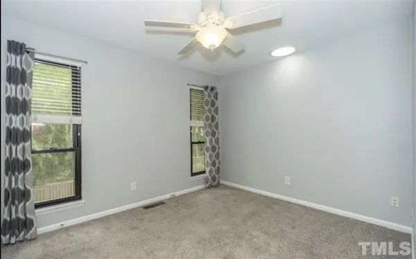 an empty room with windows and closet