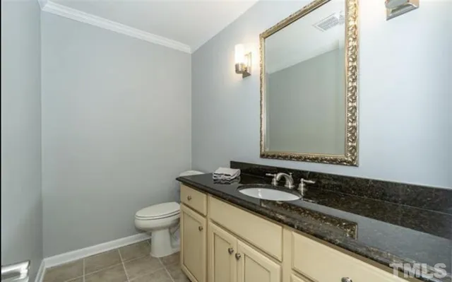 a bathroom with a granite countertop sink a large mirror and toilet