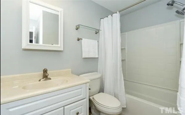 a bathroom with a sink toilet a mirror and shower