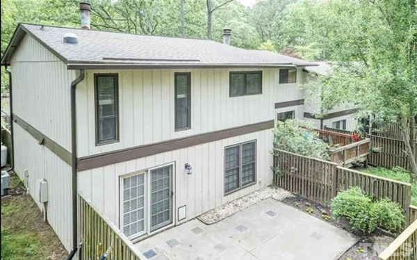 a view of a house with wooden fence