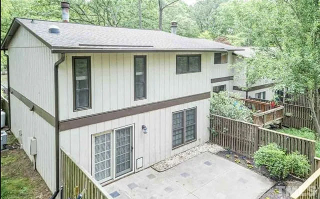 a view of a house with wooden fence
