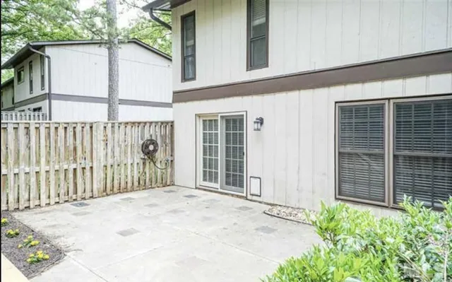 a view of a house with a wooden fence