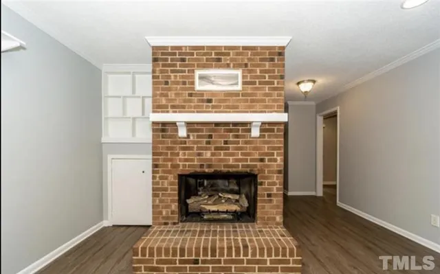 a living room with a fireplace and a rug