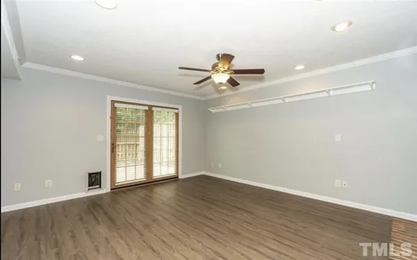 wooden floor in an empty room with a window
