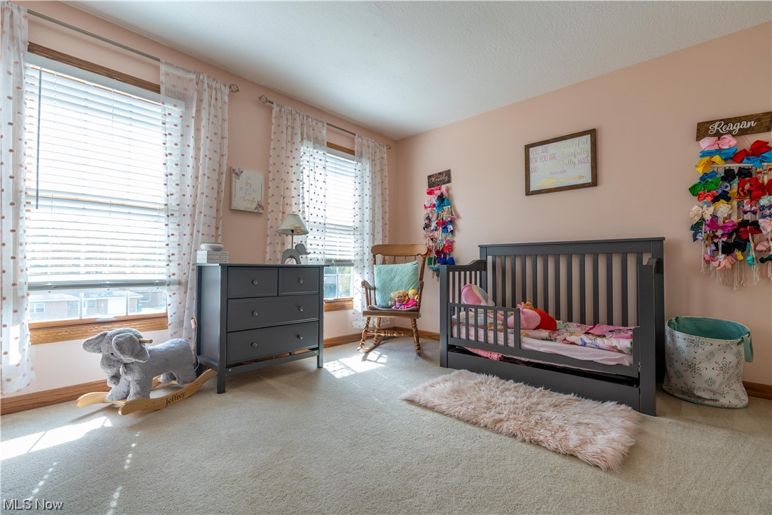 939 Pontius Road Mogadore, OH 44260 - Photo 23 of 35 Carpeted bedroom featuring a crib