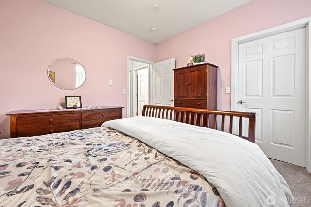 a bedroom with a large bed and a dresser