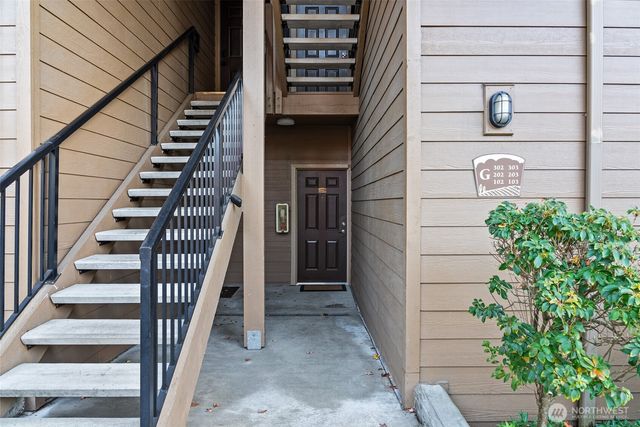a view of entryway with wooden floor and stairs