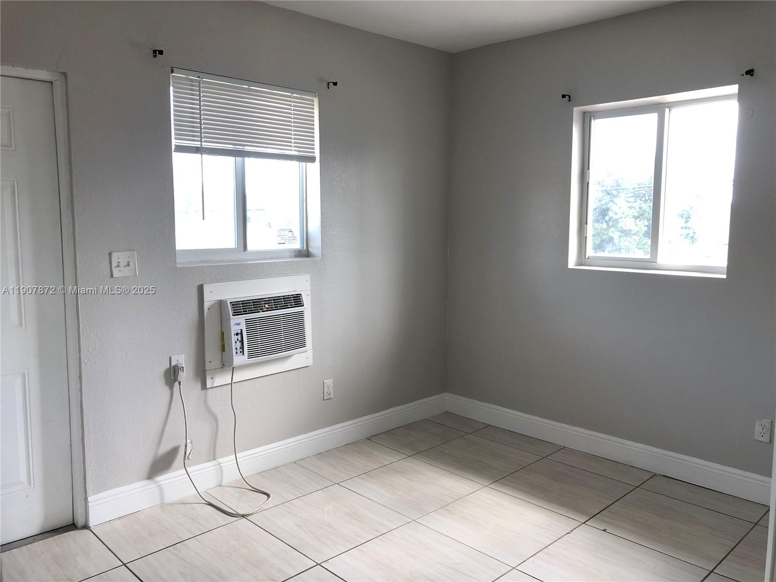 1940 Washington Avenue, Unit 11 Opa-Locka, FL 33054 - Photo 13 of 14 an empty room with windows
