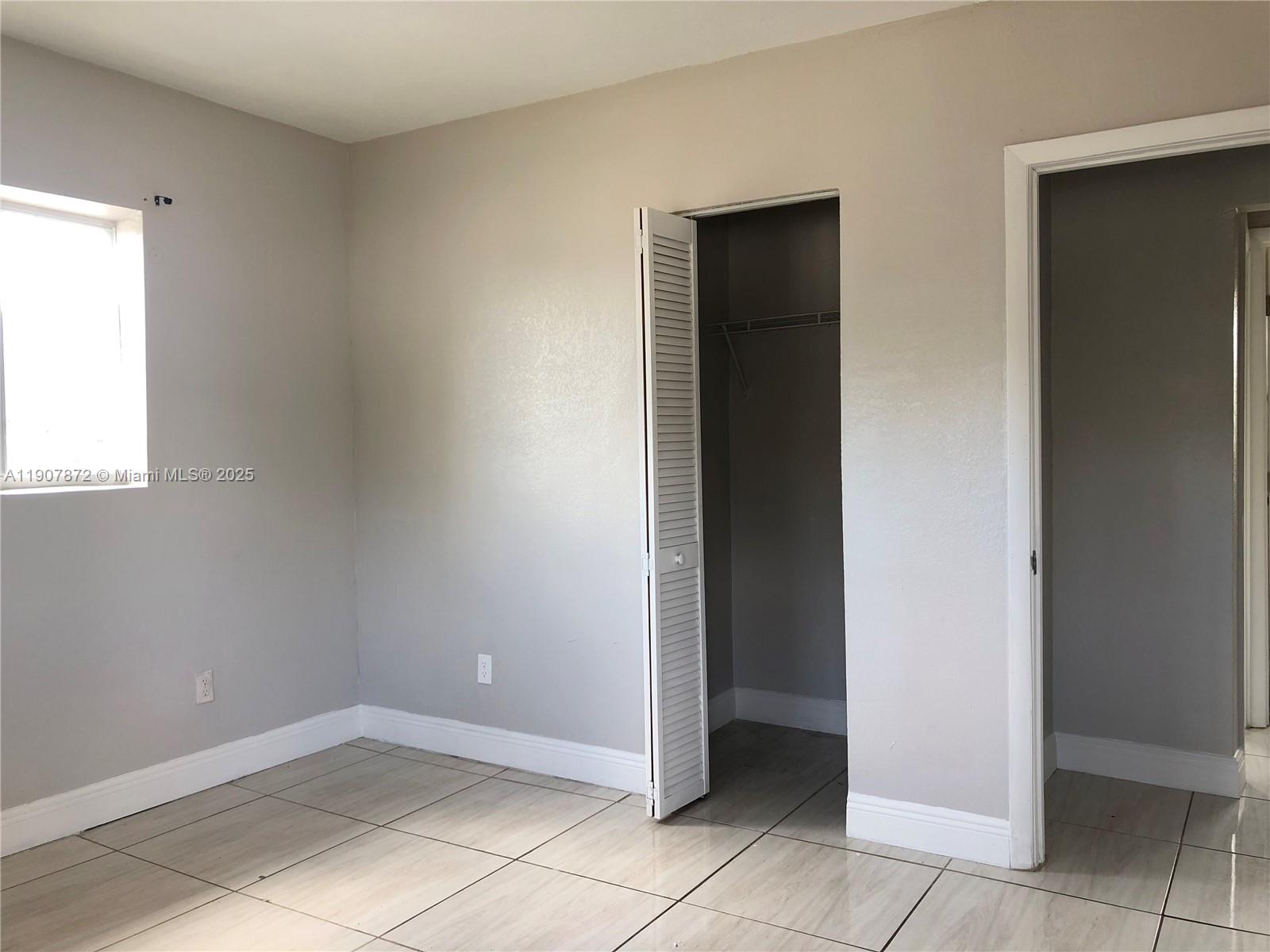 1940 Washington Avenue, Unit 11 Opa-Locka, FL 33054 - Photo 8 of 14 an empty room with windows