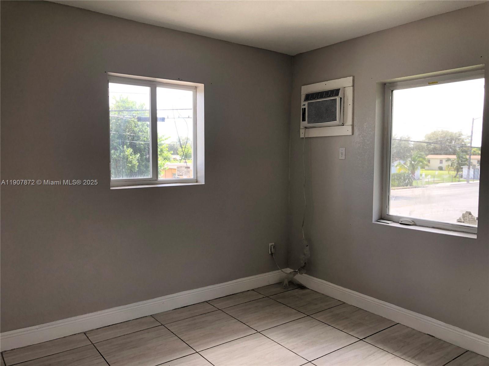 1940 Washington Avenue, Unit 11 Opa-Locka, FL 33054 - Photo 10 of 14 an empty room with windows
