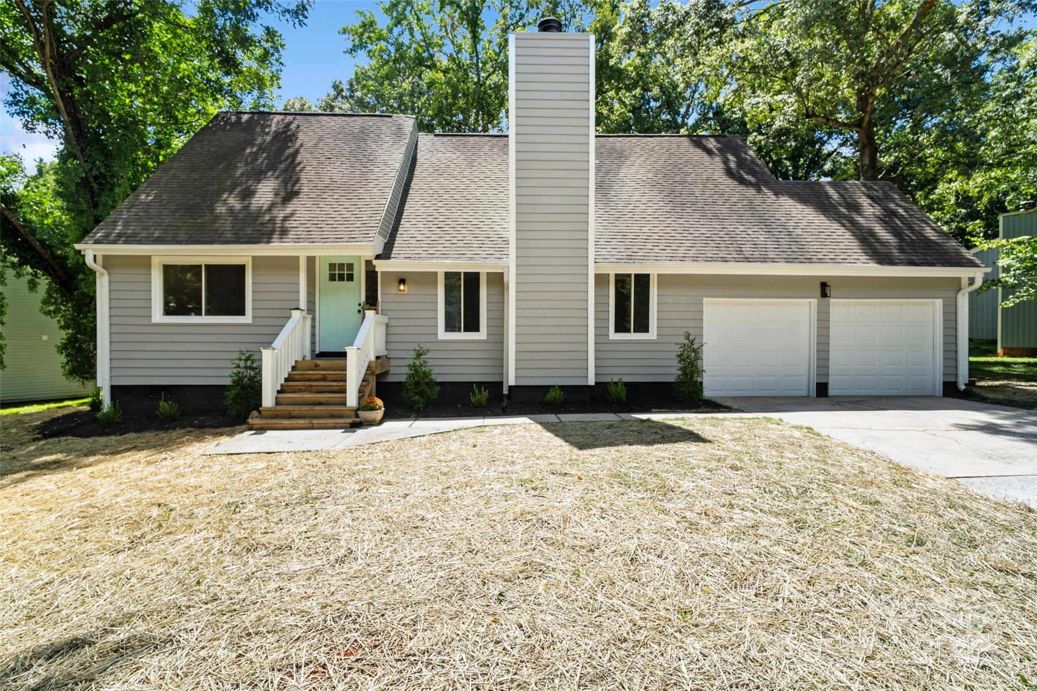 a house that has a tree in front of it