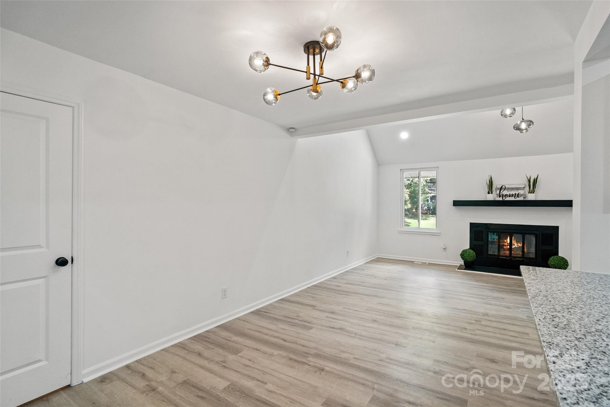 9514 Fairway Ridge Road Charlotte, NC 28277 - Photo 11 of 36 a view of an empty room with wooden floor fireplace and a window