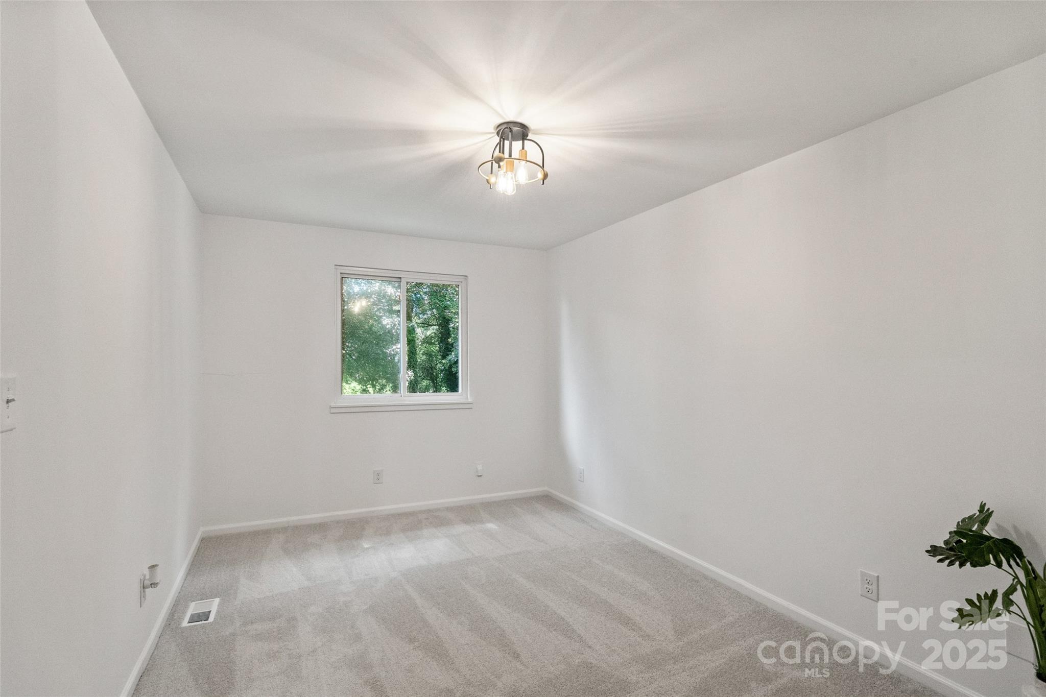 9514 Fairway Ridge Road Charlotte, NC 28277 - Photo 27 of 36 an empty room with windows and ceiling fan