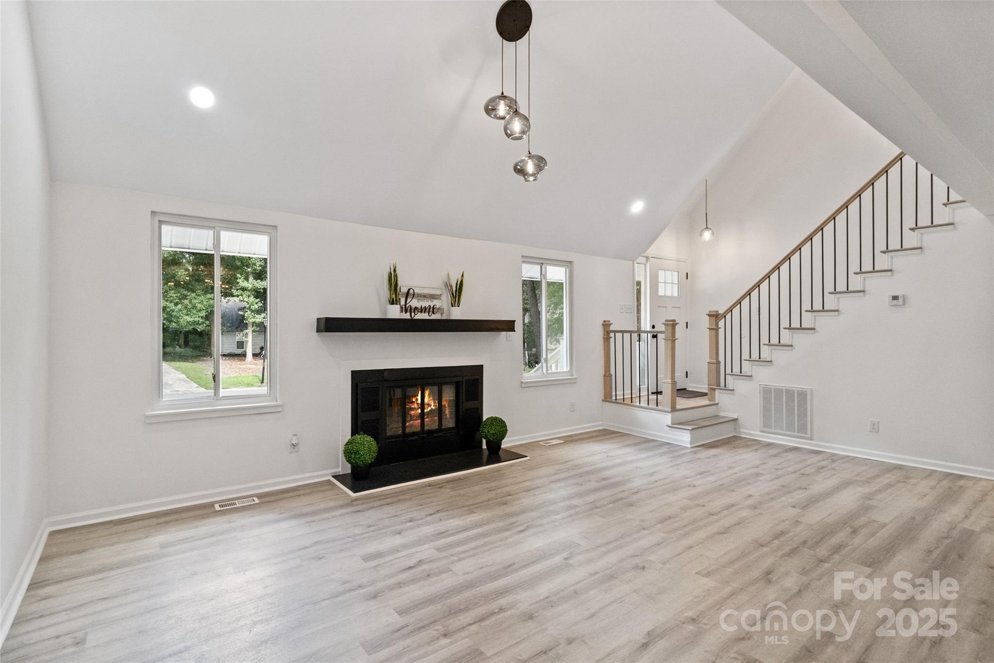 9514 Fairway Ridge Road Charlotte, NC 28277 - Photo 8 of 36 a view of an empty room with wooden floor fireplace and a window