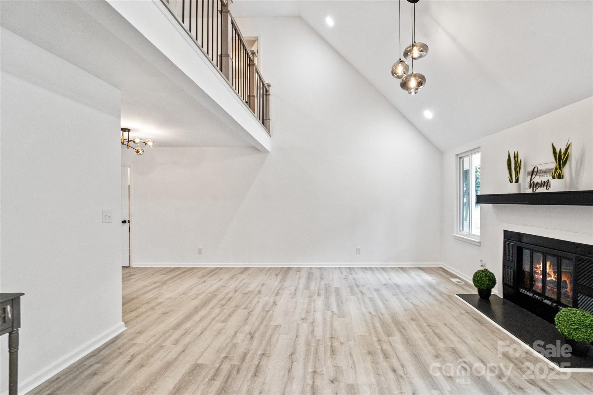 9514 Fairway Ridge Road Charlotte, NC 28277 - Photo 9 of 36 a view of empty room with wooden floor and fireplace