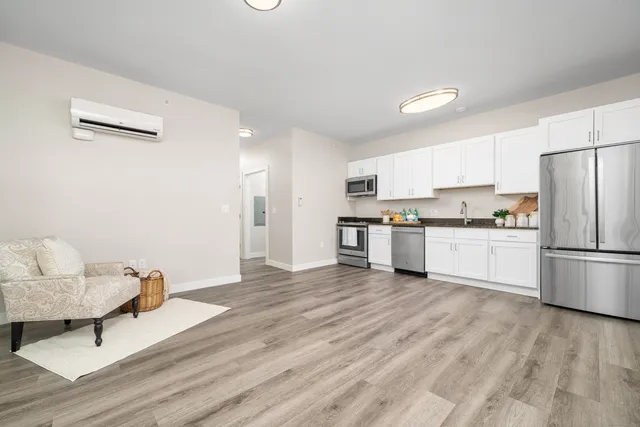 a kitchen with stainless steel appliances a refrigerator sink and cabinets
