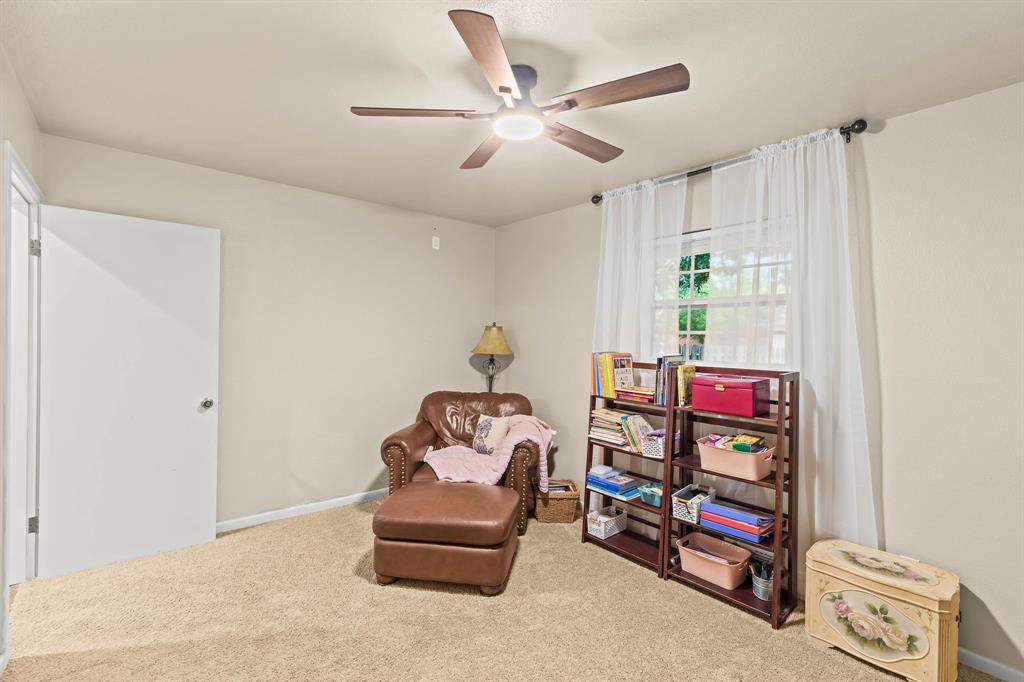 934 North Maple Street Muenster, TX 76252 - Photo 21 of 39 a bedroom with bed and a chandelier