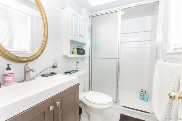 a bathroom with a sink toilet and mirror