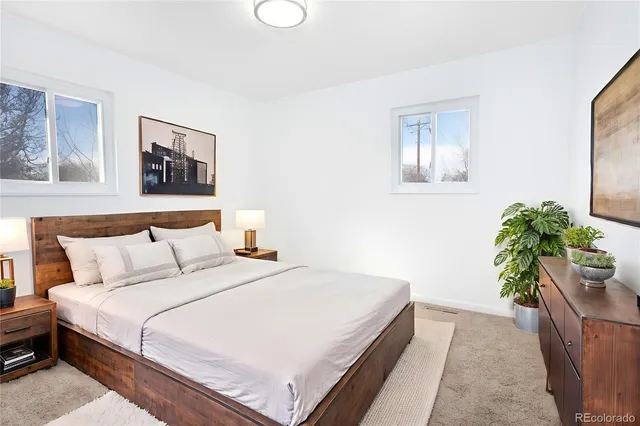 a bedroom with a bed and a potted plant