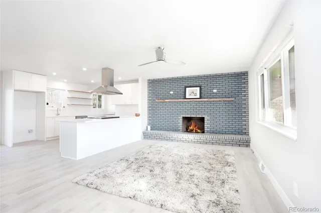 a view of a kitchen with furniture and a fireplace