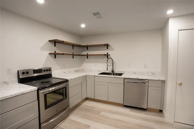 a kitchen with cabinets and appliances
