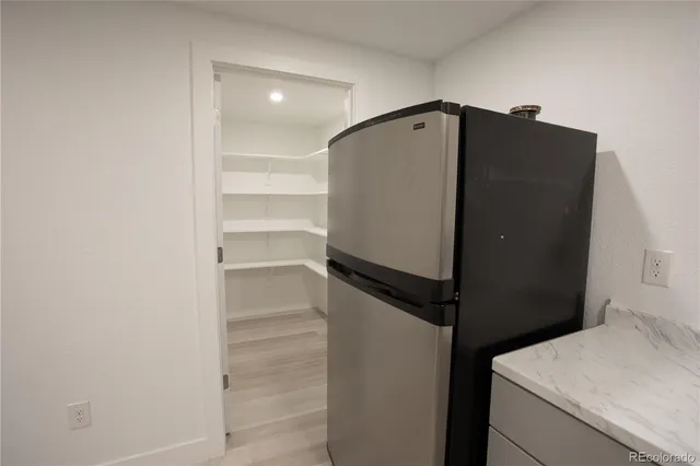 a utility room with wooden floor washer and dryer