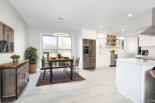a dining room with furniture a window and stainless steel appliances