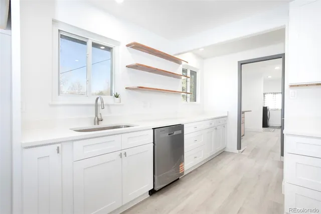 a kitchen with white cabinets and white appliances