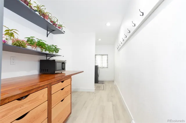 a hallway with a potted plant on the wall