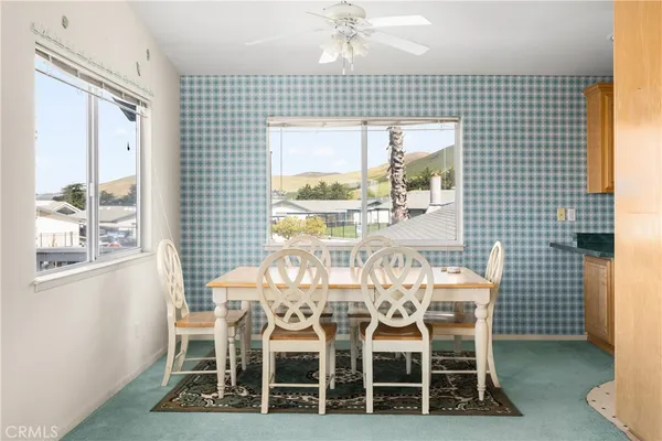 a view of a dining room with furniture window and outside view