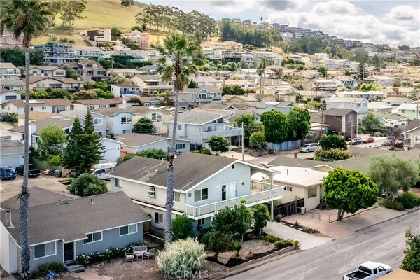 an aerial view of residential houses with green space