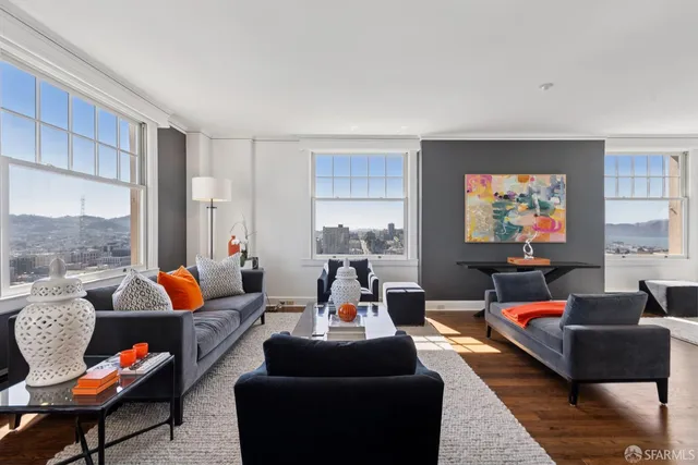 a living room with furniture and a chandelier
