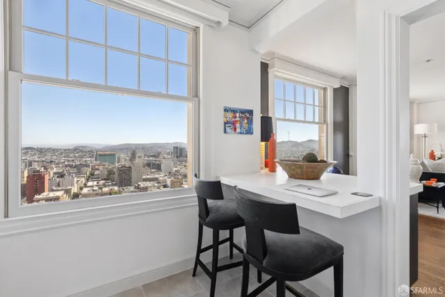 a kitchen with a white cabinets sink and wooden floor