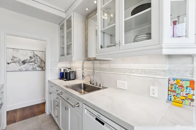 a kitchen with stainless steel appliances granite countertop a sink and a stove