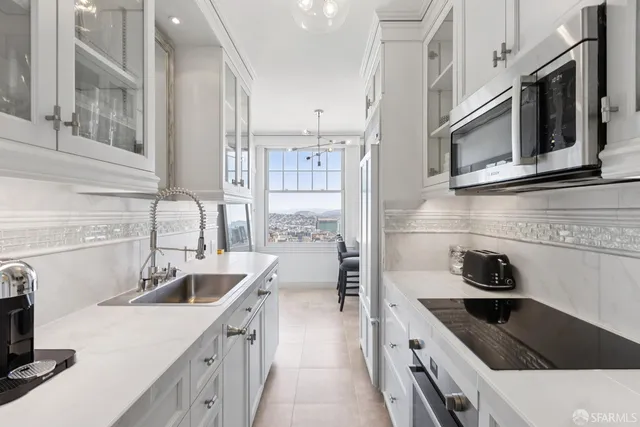 a view of a hallway with wooden floor and cabinet