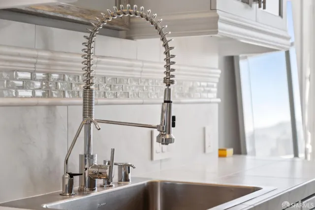 a bedroom with a bed a couch and large window