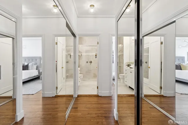 a view of a living room filled with furniture and a window