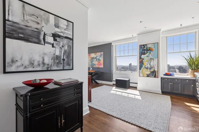 a living room with furniture and wooden floor